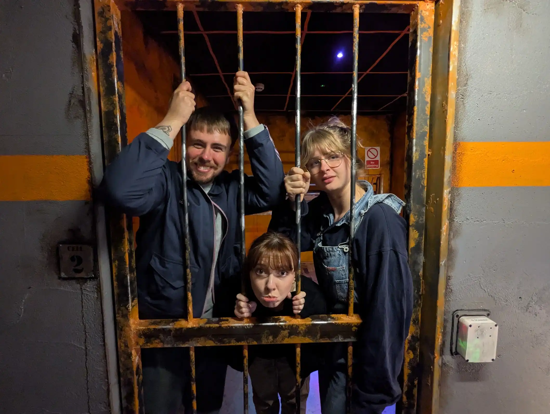 Players behind bars in The Jail escape room, Glasgow
